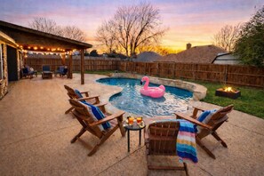 A backyard with a swimming pool, lounge chairs, a tiki bar, and a fire pit. - Keller Charm-Near Bear Creek Park & Stadiums,Pool (Keller)