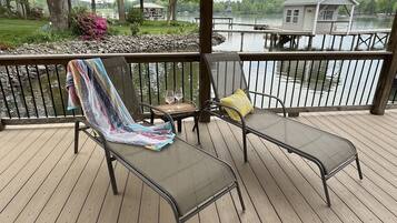 Relax on the deck overlooking the water with comfortable lounge chairs and a cozy blanket.