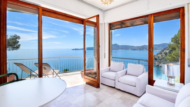 A spacious balcony with a clear view of the sea and distant land.