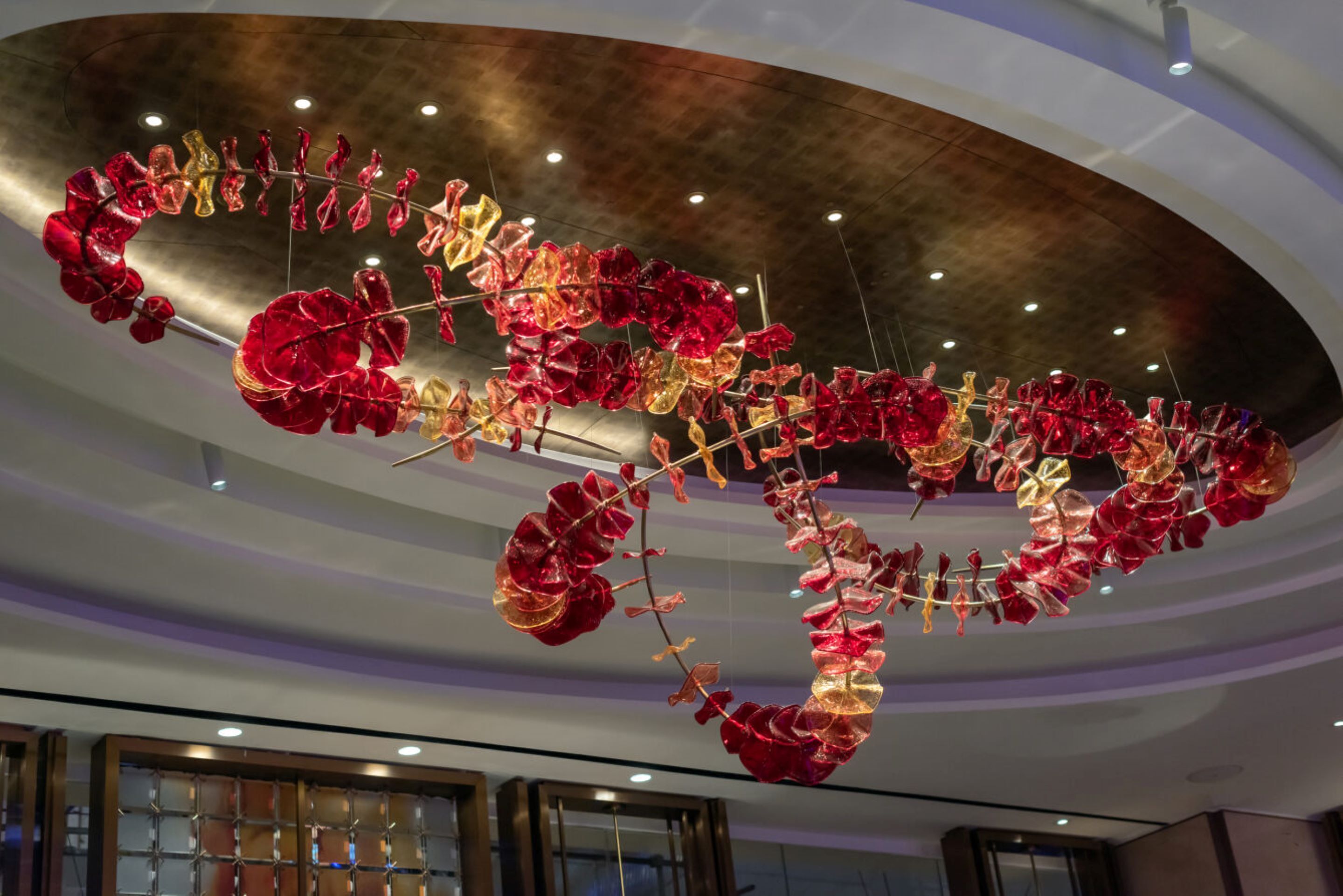 A ceiling with a large, abstract glass sculpture.