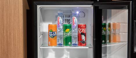 Un refrigerador con varias latas de bebidas.