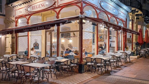 A restaurant with outdoor seating and a checkered floor pattern. - Coastal Sunset By My Getaways (Brighton)