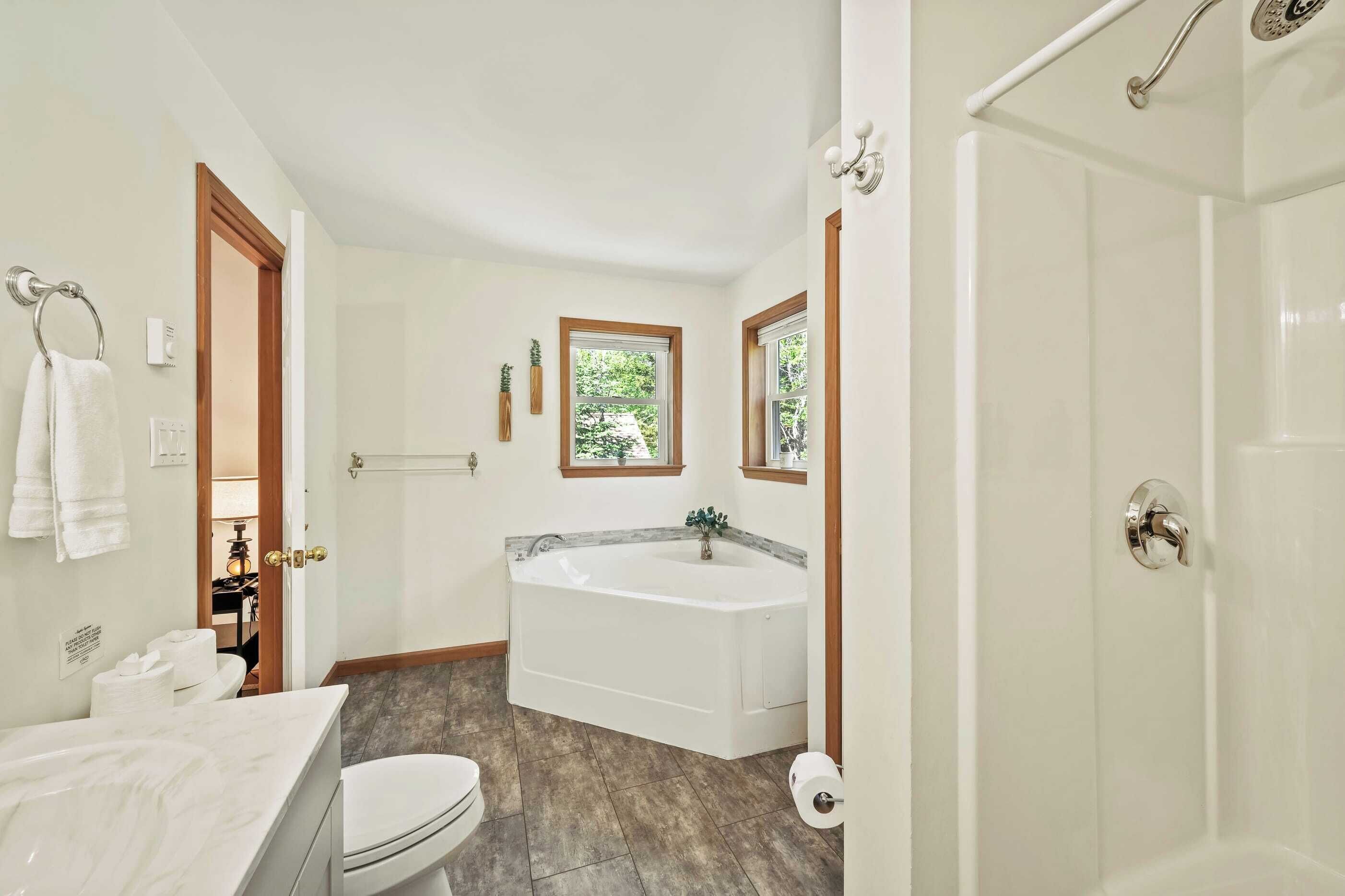 A bathroom with a bathtub, toilet, and sink.