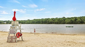 A lifeguard chair with signs indicating no lifeguard on duty and no lifeguard required. - The Nest at Brier Crest by Avantstay Game Room, Expansive Deck & Fire Pit (Blakeslee)