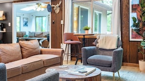 A cozy living room with a sofa, armchair, and coffee table.