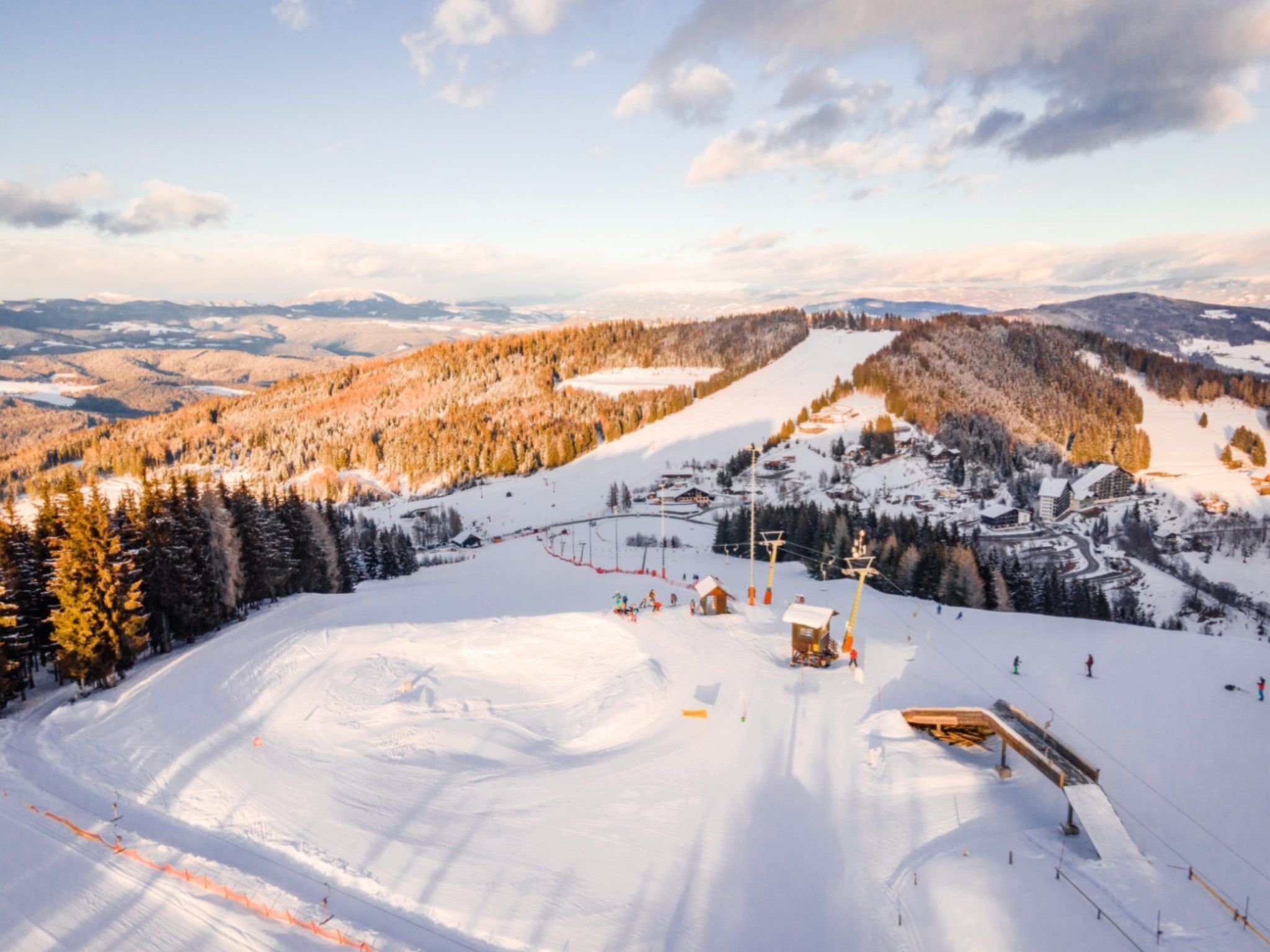 A ski resort with a chairlift, ski slopes, and a lodge.