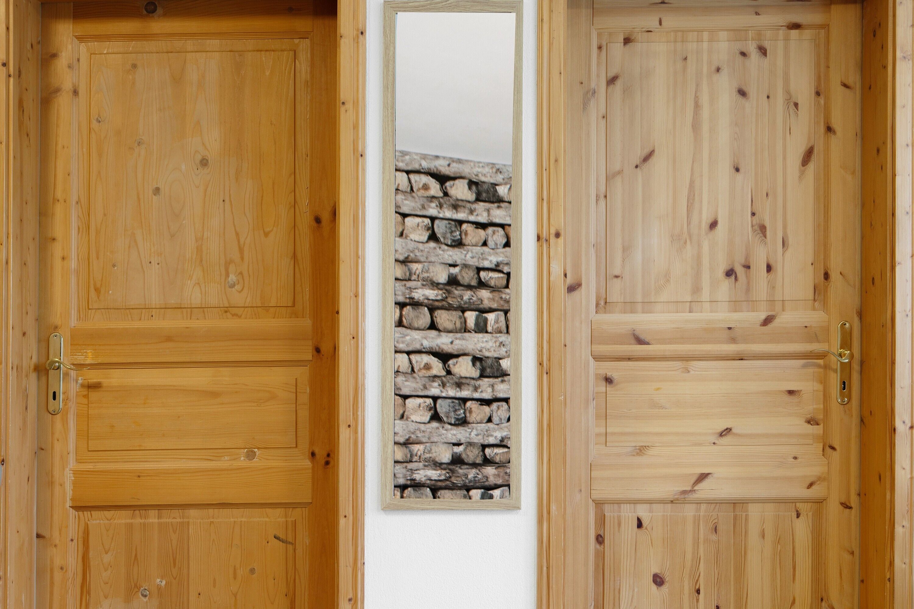 A wooden door with a stone wall behind it.