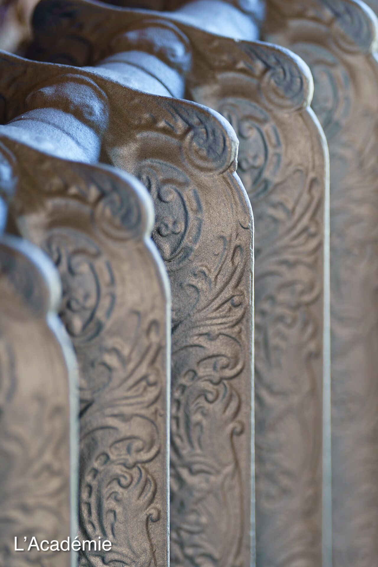 A close-up of a row of intricately carved wooden furniture pieces, likely part of a hotel or historic building's interior.