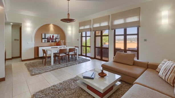 A spacious living area with a sofa, coffee table, and dining table. - 2 Bedroom Apartment - AHI02 (paphos)