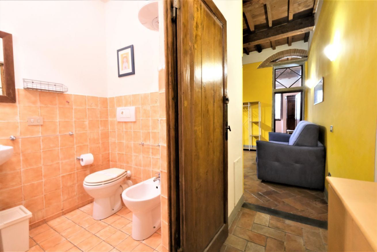 A bathroom with a toilet, bidet, and sink.