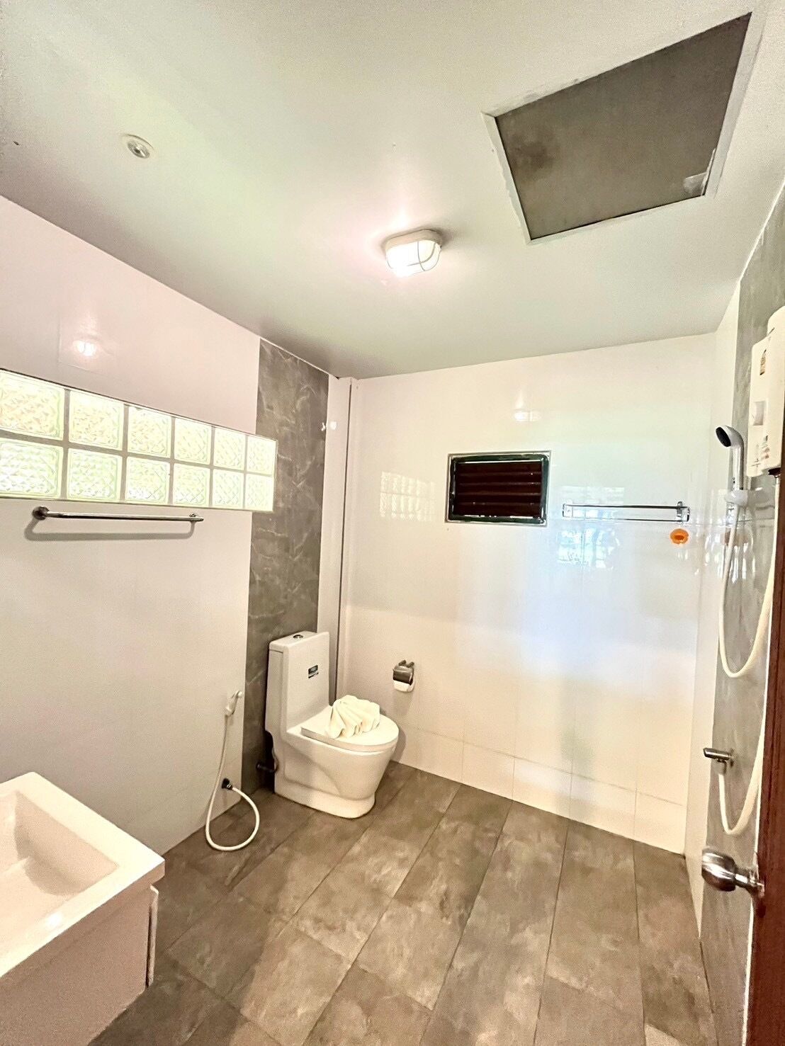 A modern bathroom with a toilet, bidet, and shower.