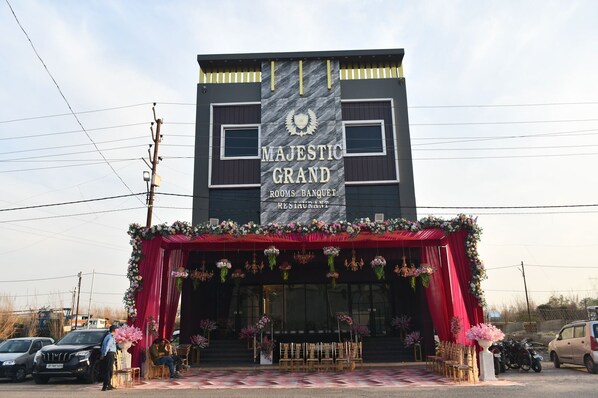 A building with a sign reading "MAJESTIC GRAND ROOMS BANGUET RESTAURANT".