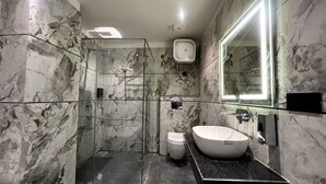 A modern bathroom with a glass-enclosed shower, a white sink, and a large mirror. - Hotel Majestic Grand By MNG Rooms (Kanpur)