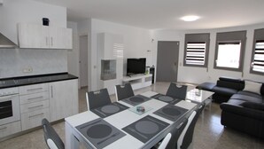 A modern living space with a dining area, kitchen, and seating area. - Beachside Oasis: Private Pool, Optional A/C, Free Wi-Fi, Pet Friendly, Near Dog Beach (Deltebre)
