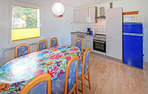 Enjoy meals in the kitchen with a modern stove, microwave, and oven, and dine at the table with comfortable chairs.