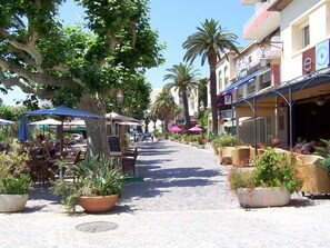 Relax in a tranquil outdoor setting surrounded by lush greenery and Mediterranean architecture.