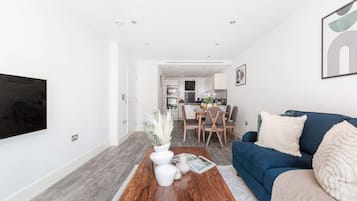 City Apartment | Living area | 40-inch Smart TV with satellite channels