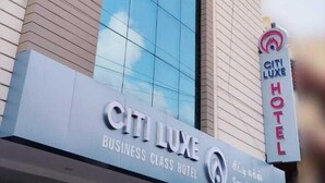A building with a large glass window and a sign that reads "CITI LUXE BUSINESS CLASS HOTEL". - Citi Luxe Hotel (Chennai)
