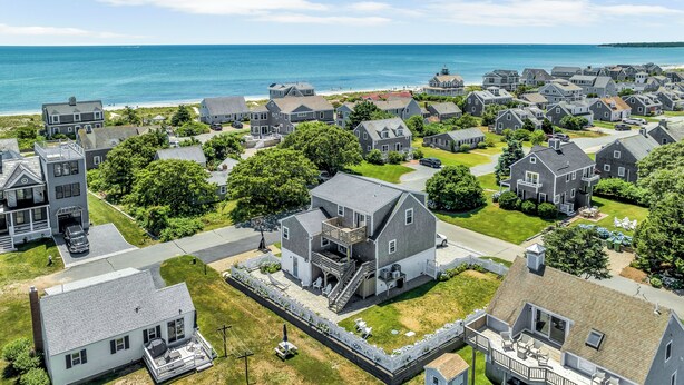 A coastal residential area with houses, a beach, and a clear view of the ocean. - Beautiful Great Island Ocean Club Home (2368) (Yarmouth)
