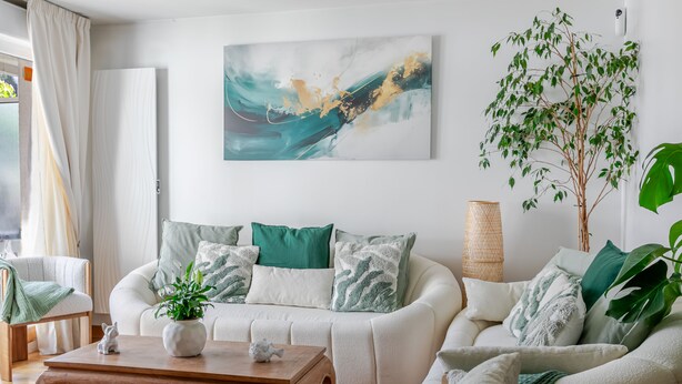 A modern living room with a white sofa set, a wooden coffee table, and a large abstract painting on the wall. - A little sun in Paris with balconies, 15 minutes from Porte de Versailles (Paris)