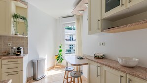 A compact kitchen with a window, a sink, and a countertop. - A little sun in Paris with balconies, 15 minutes from Porte de Versailles (Paris)