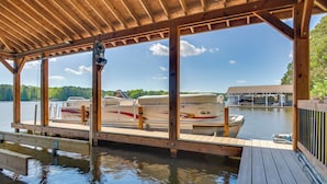 A covered dock with a view of boats on the water.