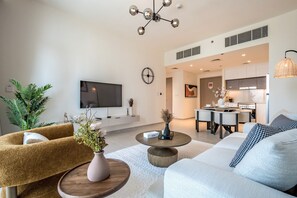 Relax in this stylish living room with a sofa set, coffee table, and wall-mounted TV.