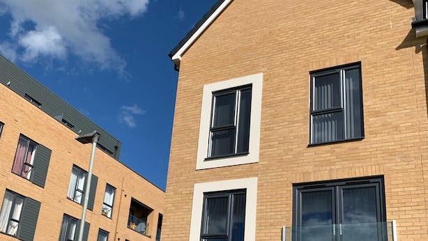 A modern apartment building with a brick facade, multiple windows, and a visible entrance. - Brand New Entire 4 Bed House/multiple Parking (South Ockendon)