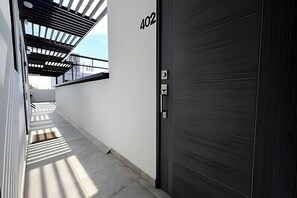 Corridor leading to a guest room with a door marked 402.
