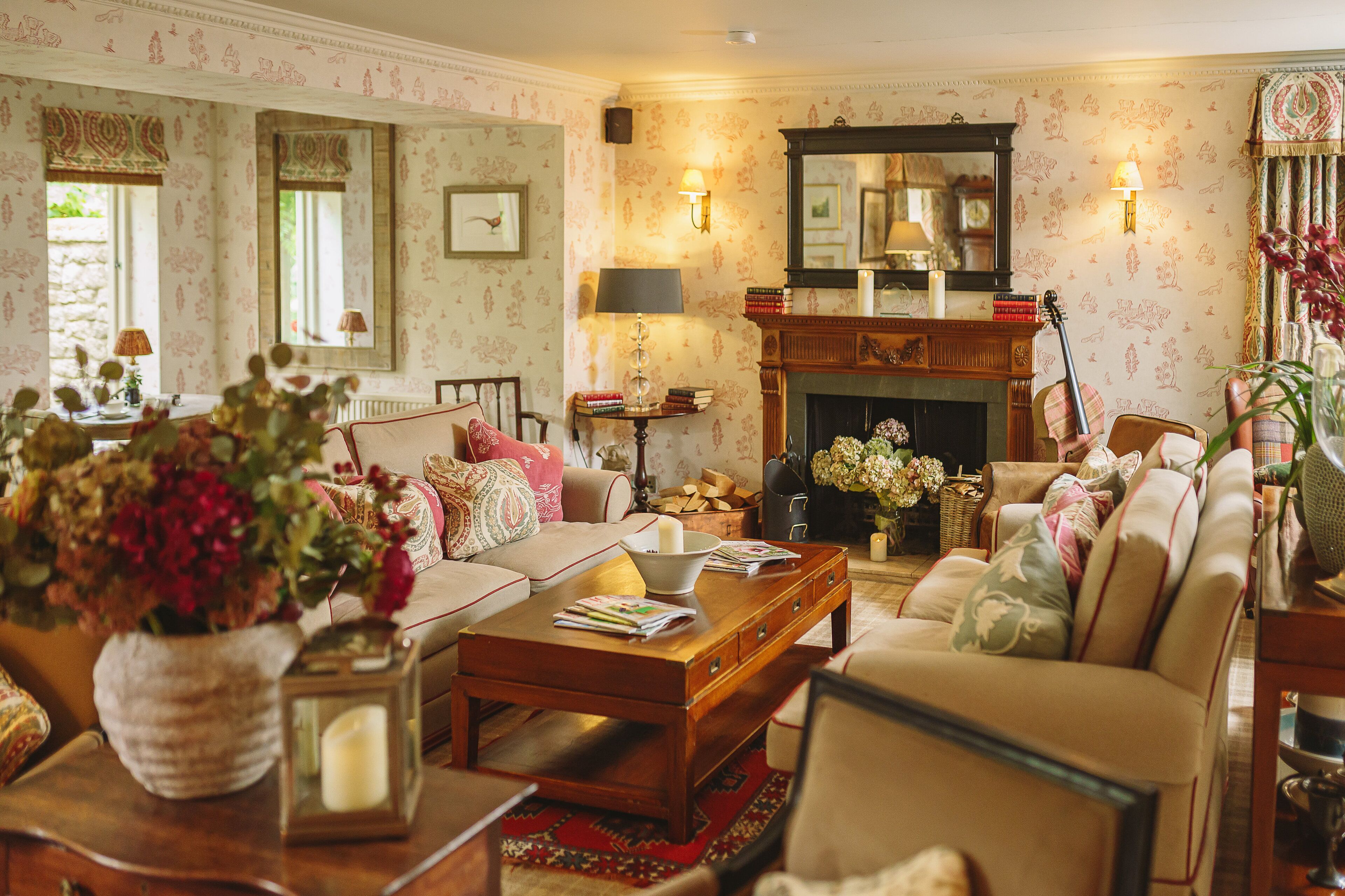 A cozy living room with a fireplace, comfortable seating, and decorative elements.