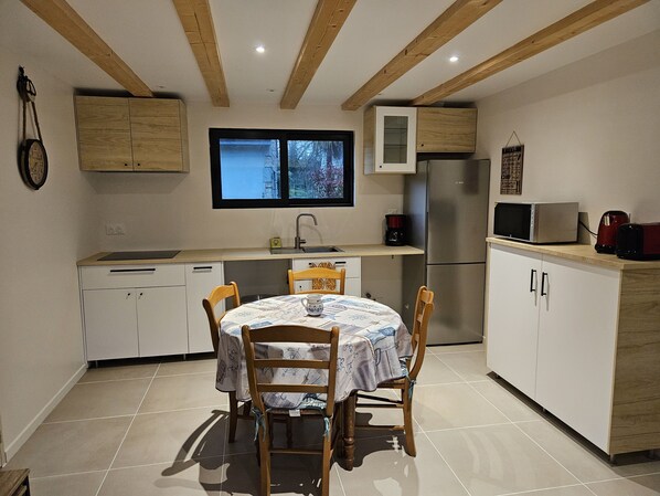 Enjoy cooking in this kitchen with a central island, dishwasher, and stainless steel refrigerator.