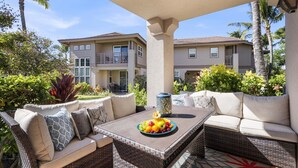 A covered outdoor seating area with wicker furniture and a fruit bowl. - *FREE LATE CHECK OUT Jun 1-Sep 30/2201 Waikoloa Colony Villas (Waikoloa Beach Resort)