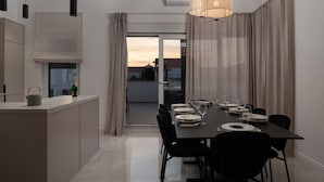 A modern kitchen with a dining area.