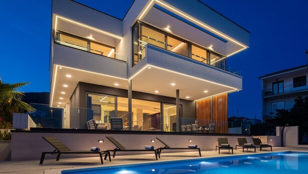 A modern two-story house with a swimming pool, large windows, and outdoor seating. - Luxury Villa Excellence with a pool (Seget Vranjica)