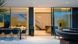 A modern interior with a dining area, a staircase, and a large glass wall. - Exclusive Villa Calma II - heated pool&spa sea view, quiet area family Paklenica (Starigrad)