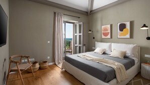 A bedroom with a large bed, a television, a balcony with a view, and a wooden floor. - Rustic Villa Reichardia with a pool in Istri, panoramic view, pet friendly (Sveti Lovrec)