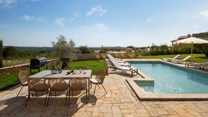 An outdoor pool area with a table and chairs, a barbecue grill, and a view of the surrounding landscape. - Rustic Villa Reichardia with a pool in Istri, panoramic view, pet friendly (Sveti Lovrec)