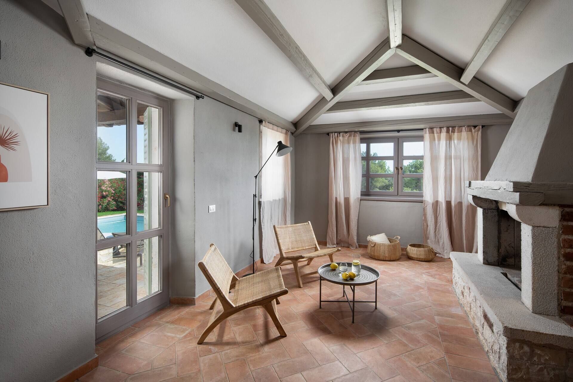 A spacious room with large windows, a fireplace, and a pool visible through the glass doors. - Rustic Villa Rorripa with a pool in Istri, panoramic view, pet friendly, quite area, family, private parking, terrace, fancy yard (Sveti Lovrec)