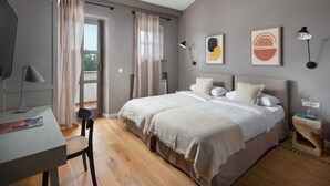 A bedroom with a bed, a desk, a chair, and artwork on the wall. - Rustic Villa Rubus with a pool in Istri, panoramic view, pet friendly (Sveti Lovrec)