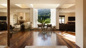 A spacious living room with a large window, a fireplace, and a dining area with a view of the outdoors. - Exclusive Villa Marnano - Split, sea view, near center, concierge services, jacuzzi (Split)