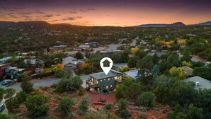 An aerial view of a residential area with a prominent house marked by a location pin.