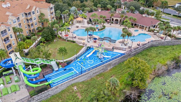 A resort with two swimming pools, a water park, and a natural pond with lily pads.