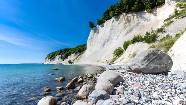 A rocky beach with large boulders and a steep cliff. - Hotel Rügenschmiede vis a vis Hiddensee (Schaprode)