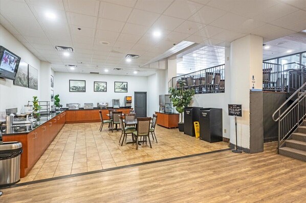 A spacious lobby with a reception desk, seating area, and a staircase leading to upper floors. - Lake Superior Loft - Sleeps 10, Heart of Canal Park, Lake Superior View (Duluth)