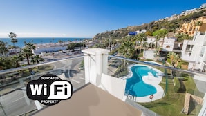 A property with a dedicated WiFi area, a swimming pool, and a view of the ocean.