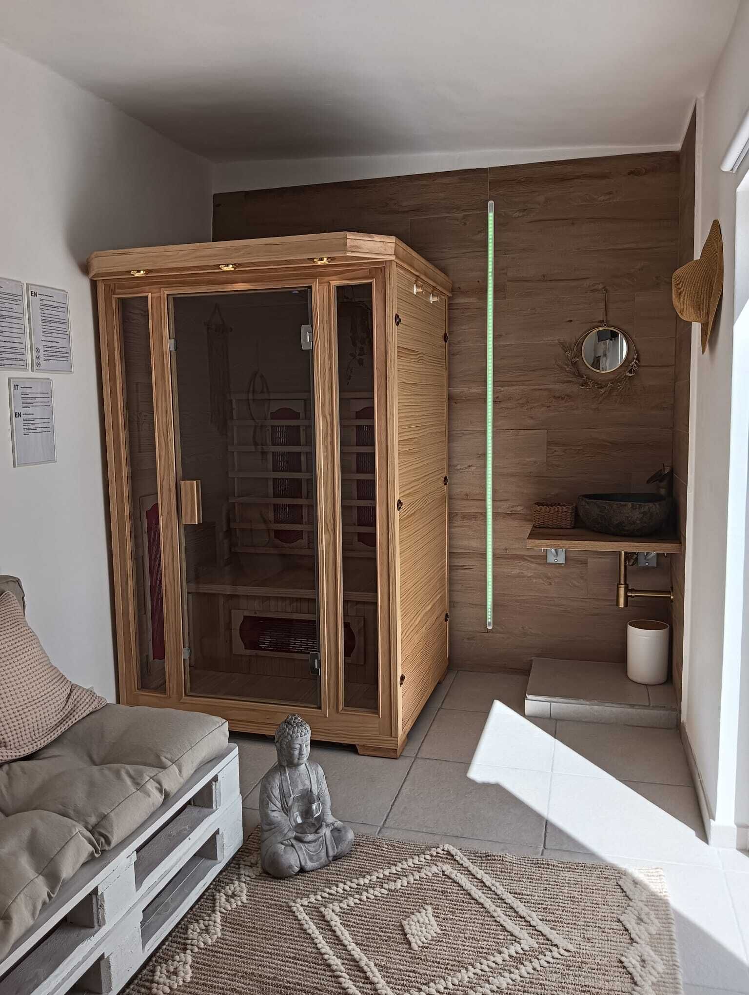 A room with a wooden cabinet, a small statue, a mirror, and a shelf with a bowl.
