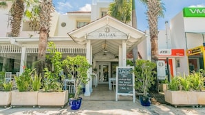 A building with a sign reading "DALLAS" and a signboard with text. - Magic Cortesea luxury beach (Punta Cana)