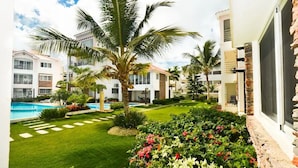 A resort with a swimming pool, palm trees, and well-maintained gardens. - Magic Cortesea luxury beach (Punta Cana)