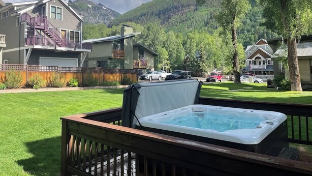 A hot tub on a deck with a mountain backdrop. - Vibrant Central Telluride Studio w Hot Tub (Telluride)