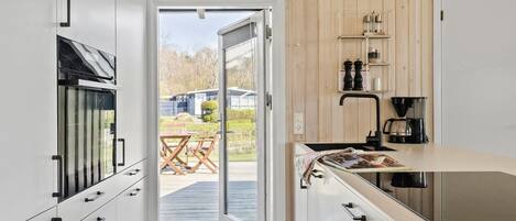 Fridge, stovetop, dishwasher, coffee/tea maker